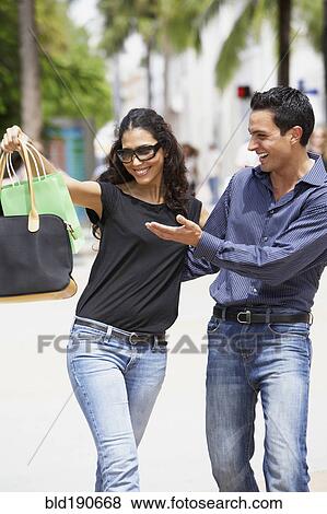 Stock Photo - Couple looking at shopping bag. Fotosearch