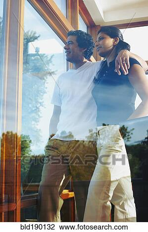 Couple looking through window View Large Photo Image Stock Image - Couple looking through window. Fotosearch
