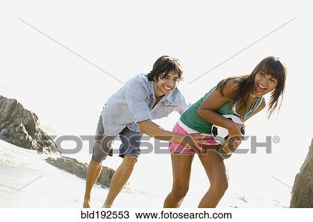 Couple playing with soccer ball on beach View Large Photo Image Stock Image - Couple playing with soccer ball on beach. Fotosearch