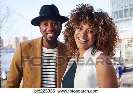 Stock Photograph - Couple smiling at waterfront. Fotosearch