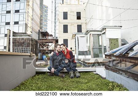 Couple smiling in urban rooftop garden View Large Photo Image Stock Image - Couple smiling in urban rooftop garden. Fotosearch