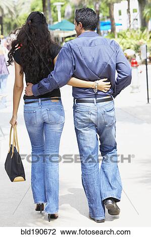 Couple walking arm in arm View Large Photo Image Stock Image - Couple walking arm in arm. Fotosearch