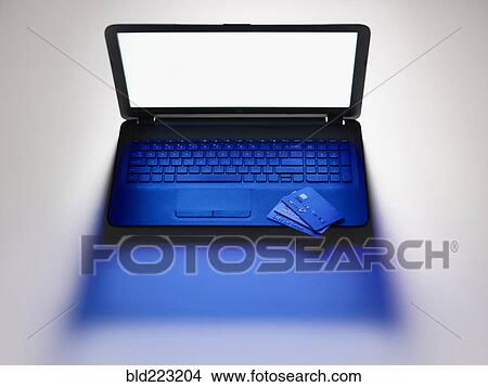 Picture - Credit cards on laptop computer. Fotosearch