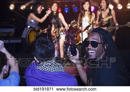 Stock Image - Crowd watching musical group perform. Fotosearch