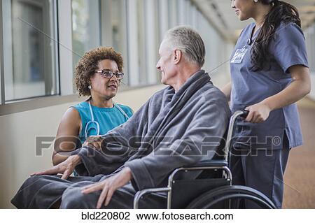 Doctor talking to patient in wheelchair View Large Photo Image Stock Image - Doctor talking to patient in wheelchair. Fotosearch