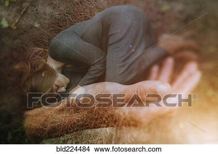 Picture - Double exposure of Caucasian woman laying in hand of man. Fotosearch