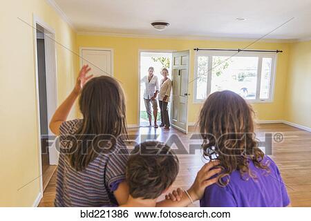Stock Photograph - Family admiring new home. Fotosearch