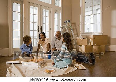 Family eating on floor in new home View Large Photo Image Stock Photo - Family eating on floor in new home. Fotosearch