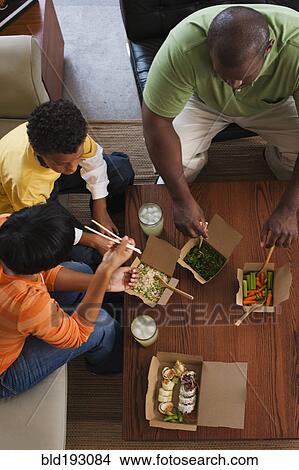 Picture - Family eating take-out Asian food. Fotosearch