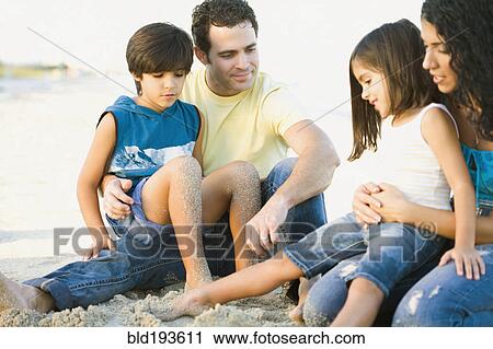 Stock Image - Family enjoying the beach. Fotosearch