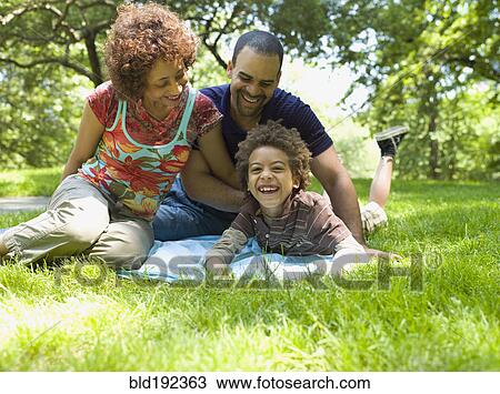 Stock Image - Family having fun in park. Fotosearch