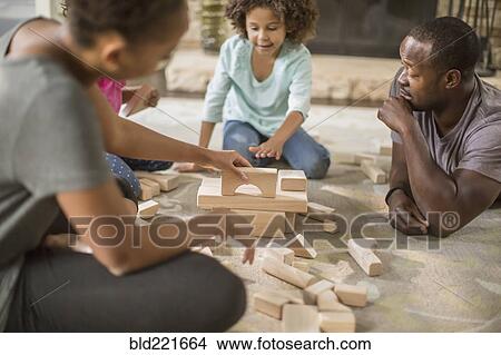 Family playing with building blocks in living room View Large Photo Image Picture - Family playing with building blocks in living room. Fotosearch