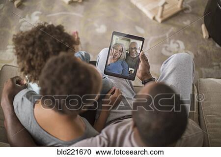 Family video chatting with digital tablet View Large Photo Image Stock Image - Family video chatting with digital tablet. Fotosearch