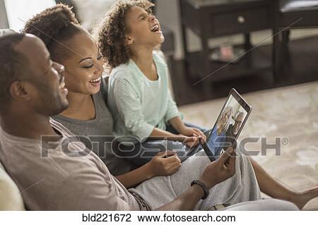 Family video chatting with digital tablet View Large Photo Image Stock Image - Family video chatting with digital tablet. Fotosearch