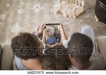 Family video chatting with digital tablet View Large Photo Image Stock Image - Family video chatting with digital tablet. Fotosearch