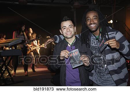 Stock Image - Fans with VIP passes backstage. Fotosearch