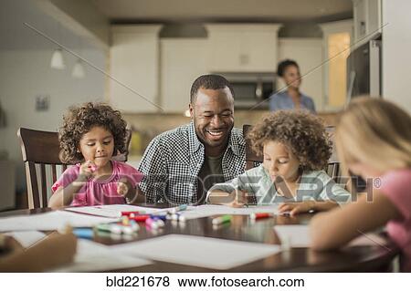 Stock Photo - Father and children drawing in kitchen. Fotosearch