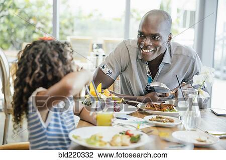 Father and daughter eating at restaurant View Large Photo Image Stock Image - Father and daughter eating at restaurant. Fotosearch