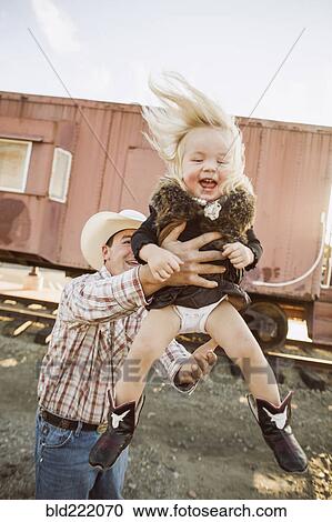 Stock Image - Father and daughter playing outdoors. Fotosearch