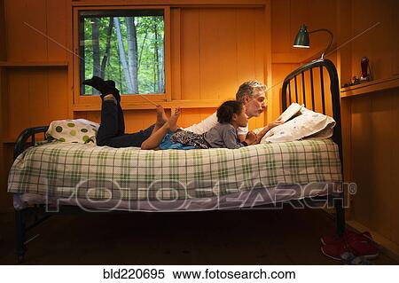 Father and daughter reading on bed View Large Photo Image Stock Photography - Father and daughter reading on bed. Fotosearch