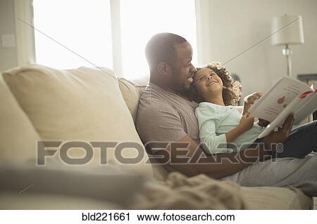 Father and daughter reading on sofa View Large Photo Image Stock Image - Father and daughter reading on sofa. Fotosearch