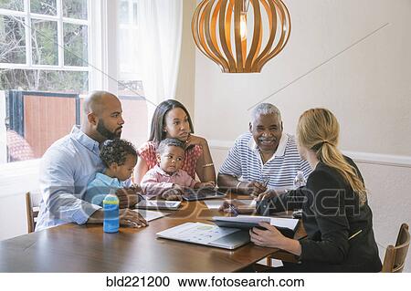 Stock Image - Financial advisor talking to clients. Fotosearch