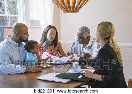 Stock Image - Financial advisor talking to clients. Fotosearch