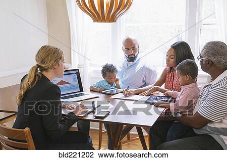 Stock Image - Financial advisor talking to clients. Fotosearch