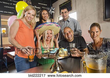Stock Photo - Friends celebrating birthday in cafe. Fotosearch