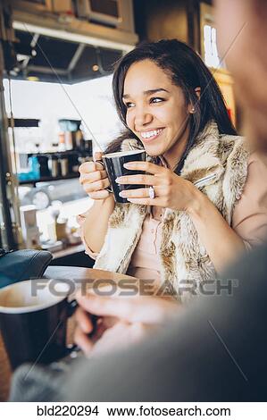 Picture - Friends drinking coffee in cafe. Fotosearch