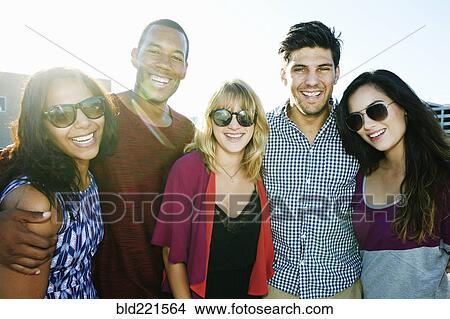 Picture - Friends smiling outdoors. Fotosearch