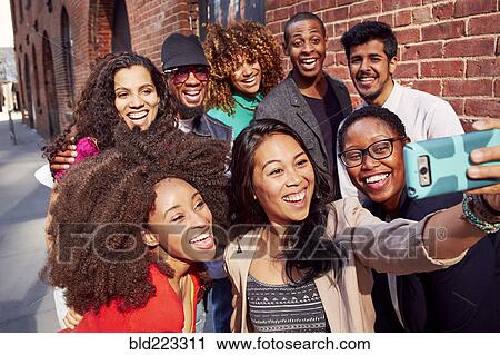 Friends talking selfie on city sidewalk View Large Photo Image Stock Image - Friends talking selfie on city sidewalk. Fotosearch