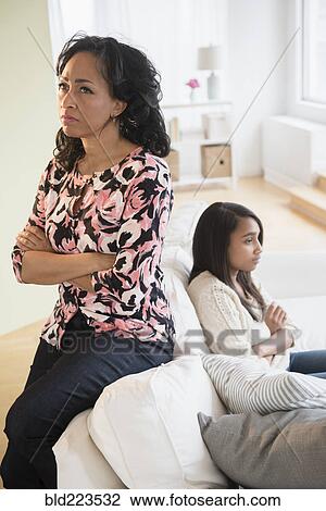 Frustrated mother and daughter sitting on sofa View Large Photo Image Stock Image - Frustrated mother and daughter sitting on sofa. Fotosearch