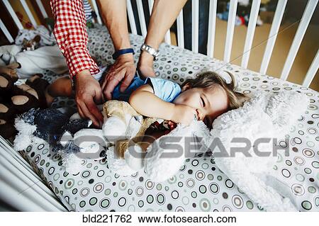 Gay fathers tickling baby son in crib View Large Photo Image Stock Image - Gay fathers tickling baby son in crib. Fotosearch