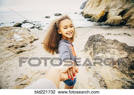 Girl pulling hand of mother on beach View Large Photo Image Stock Image - Girl pulling hand of mother on beach. Fotosearch