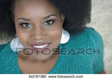 Stock Image - Glamorous mixed race woman smiling. Fotosearch