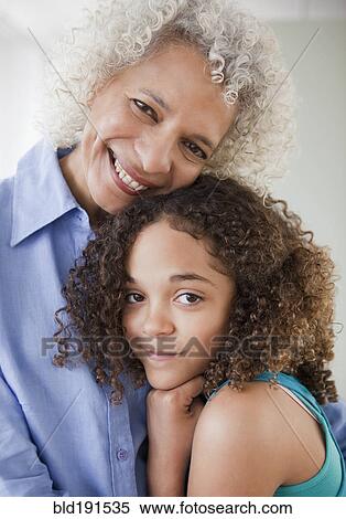 Stock Photography - Grandmother and granddaughter hugging. Fotosearch