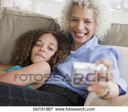 Stock Photo - Grandmother and granddaughter taking self-portrait. Fotosearch
