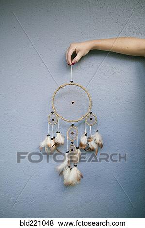 Stock Photo - Hand holding dream catcher. Fotosearch
