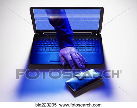 Stock Photography - Hand of hacker reaching for wallet from screen of laptop. Fotosearch