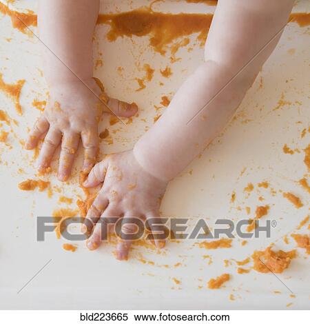hands of Caucasian baby girl self-feeding mashed sweet potato View Large Photo Image Stock Photography - hands of Caucasian baby girl self-feeding mashed sweet potato. Fotosearch
