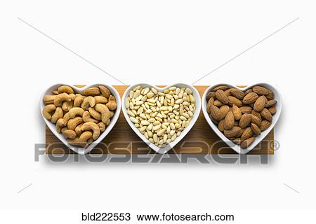 Heart-shaped bowls of heart-healthy nuts View Large Photo Image Stock Image - Heart-shaped bowls of heart-healthy nuts. Fotosearch
