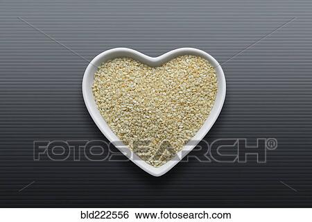 Stock Photograph - Heart-shaped bowls of heart-healthy seeds. Fotosearch