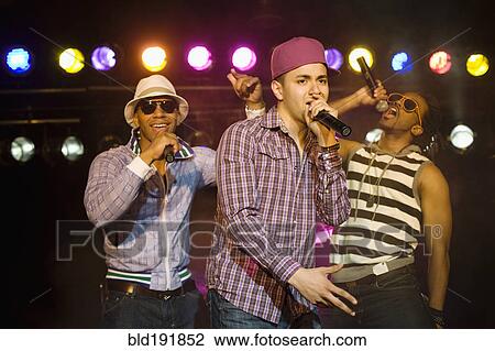 Stock Image - Hip hop musical group performing onstage. Fotosearch