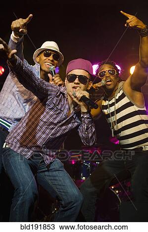 Stock Image - Hip hop musical group performing onstage. Fotosearch