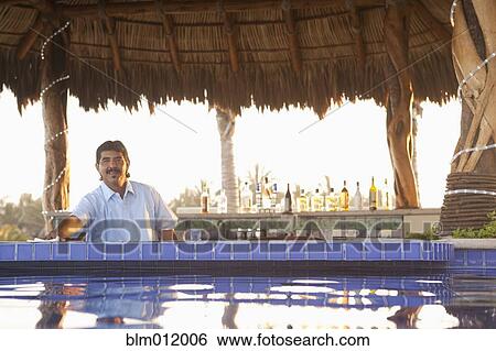 Hispanic bartender working near poolside View Large Photo Image Stock Photograph - Hispanic bartender working near poolside. Fotosearch