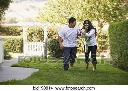 Hispanic brother and sister running on grass View Large Photo Image Picture - Hispanic brother and sister running on grass. Fotosearch