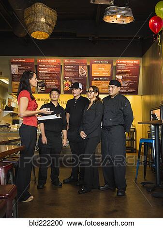 Hispanic business owner and employees talking in cafe View Large Photo Image Stock Image - Hispanic business owner and employees talking in cafe. Fotosearch