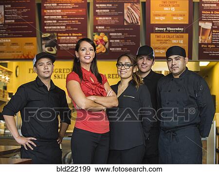 Hispanic business owner and employees smiling in cafe View Large Photo Image Stock Photo - Hispanic business owner and employees smiling in cafe. Fotosearch