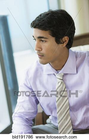 Hispanic businessman looking pensive View Large Photo Image Stock Photograph - Hispanic businessman looking pensive. Fotosearch